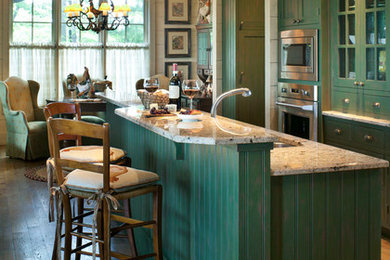 Example of a small cottage galley light wood floor eat-in kitchen design in Other with recessed-panel cabinets, green cabinets, granite countertops, stainless steel appliances and an island