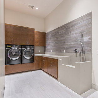 Design ideas for a medium sized contemporary l-shaped separated utility room in Las Vegas with an integrated sink, flat-panel cabinets, medium wood cabinets, composite countertops, grey walls, ceramic flooring and a side by side washer and dryer.