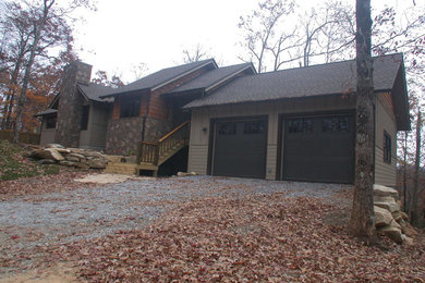 Mid-sized craftsman two-story concrete fiberboard exterior home idea in Other with a shingle roof