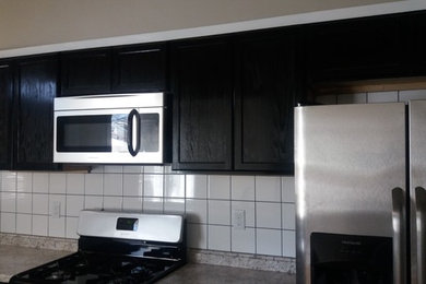 Galley laminate floor kitchen photo in Other with white backsplash and ceramic backsplash