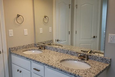 Alcove bathtub - mid-sized traditional master porcelain tile and gray floor alcove bathtub idea in Other with recessed-panel cabinets, white cabinets, granite countertops, gray countertops, beige walls and an undermount sink