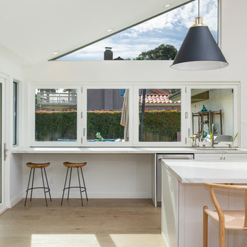 AG BiFold Patio Door & Window Pairing Connects All-White Kitchen to the Outdoors