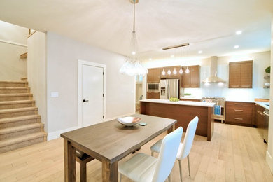 Kitchen/dining room combo - mid-sized modern light wood floor kitchen/dining room combo idea in Vancouver with white walls