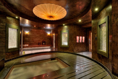 This is an example of a mid-sized asian indoor rectangular pool in San Francisco with natural stone pavers and a hot tub.