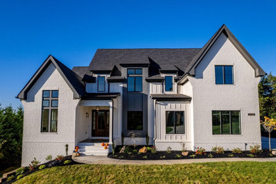 Inspiration for a white two-story brick exterior home remodel in Dallas