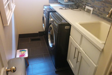 Small elegant single-wall slate floor and gray floor dedicated laundry room photo in Salt Lake City with a drop-in sink, shaker cabinets, white cabinets, beige walls and a side-by-side washer/dryer