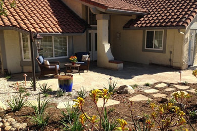 Design ideas for a mid-sized mediterranean drought-tolerant and full sun front yard stone water fountain landscape in Los Angeles for spring.
