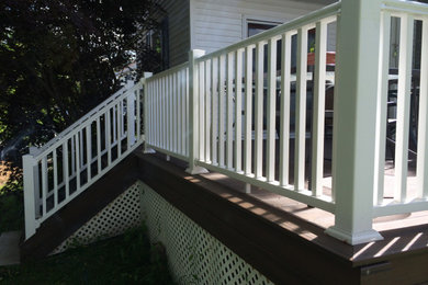 Example of a mid-sized classic backyard deck design in Boston with no cover