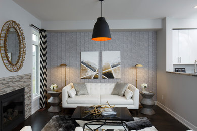 Inspiration for a small transitional open concept brown floor and wallpaper living room remodel in Ottawa with white walls, a standard fireplace and a tile fireplace