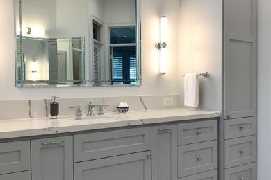 Inspiration for a transitional master white tile and ceramic tile porcelain tile, gray floor and double-sink bathroom remodel in Houston with shaker cabinets, gray cabinets, a two-piece toilet, white walls, an undermount sink, quartz countertops, white countertops, a niche and a built-in vanity