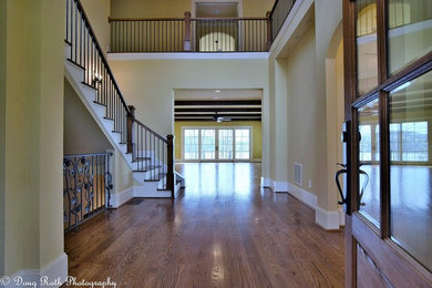 Entryway - huge traditional medium tone wood floor entryway idea in Atlanta with beige walls and a medium wood front door