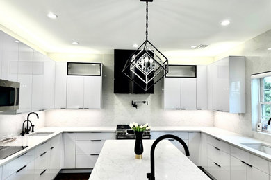 Example of a minimalist u-shaped eat-in kitchen design in New York with white cabinets, an island, white countertops, glass-front cabinets, granite countertops and stone slab backsplash