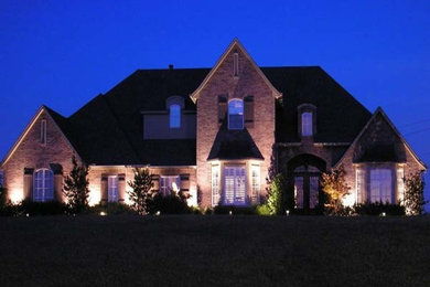 Large two-story brick gable roof idea in Other