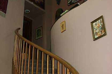 Staircase - large carpeted curved staircase idea in Denver