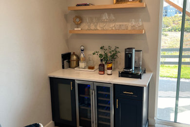 Inspiration for a small modern single-wall carpeted and gray floor dry bar remodel in Denver with shaker cabinets, blue cabinets, granite countertops and white countertops