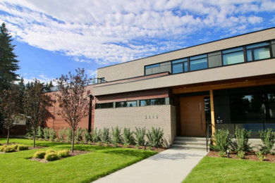 This is an example of a large contemporary partial sun front yard concrete paver landscaping in Edmonton for summer.