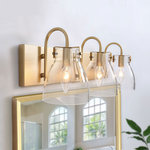 LNC - LNC 3-Light Modern Gold Bathroom Vanity Lights with Clear Glass - Leverage up the style and beauty of your decor with this modern 3-light gold vanity light. Crafted of metal in a stunning gold finish, this modern luminary features a rectangular backplate and slim bar to create a sleek and contemporary look. A trio of glass globe shades supports three bulbs to cast an ambient glow as you tackle your morning and night routines. Install it with the lights pointing up or down to suit your tastes. Plus, we recommend using an E12 regular incandescent bulb or a small round bulb-like E12 Type-B for the globe shade is a little bit small.