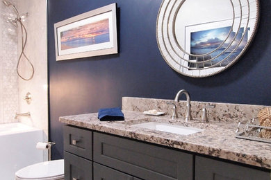 Bathroom - small transitional 3/4 white tile and mosaic tile vinyl floor bathroom idea in Jacksonville with shaker cabinets, gray cabinets, a one-piece toilet, blue walls, an undermount sink and granite countertops