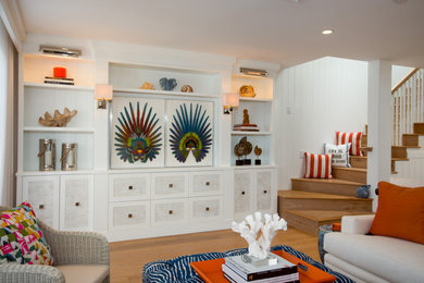 Inspiration for a mid-sized coastal open concept medium tone wood floor living room remodel with white walls