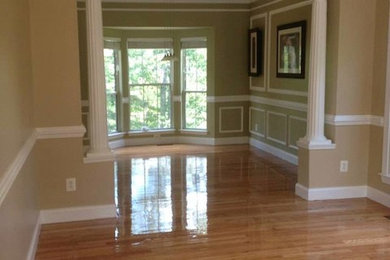 Example of a mid-sized transitional medium tone wood floor enclosed dining room design in Baltimore with beige walls