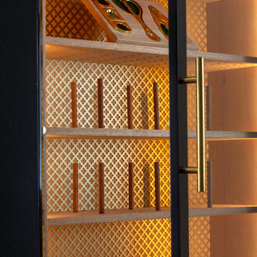 Wall hung high gloss black cigar humidor with polished brass hardware