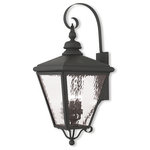 Livex Lighting Lights - Cambridge Outdoor Wall Lantern, Black - This stylish black outdoor wall lantern is a great way to update your home's exterior decor. A flat metal curved arm attaches the solid brass decorative housing to the square backplate while clear water glass protects the four bulbs.