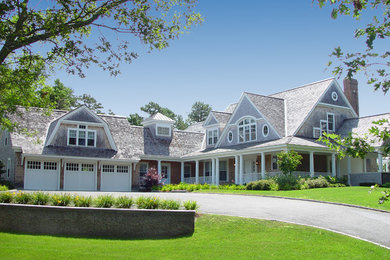 Example of a huge classic beige two-story wood exterior home design in Boston with a shingle roof