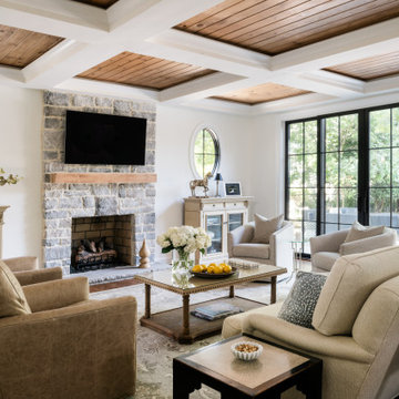 Rustic Elegance: Light-Filled Living Room with Stone Fireplace