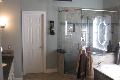 Design ideas for a large traditional master bathroom in Atlanta with raised-panel cabinets, white cabinets, a drop-in tub, a corner shower, a two-piece toilet, beige tile, porcelain tile, blue walls, porcelain floors, a wall-mount sink and engineered quartz benchtops.