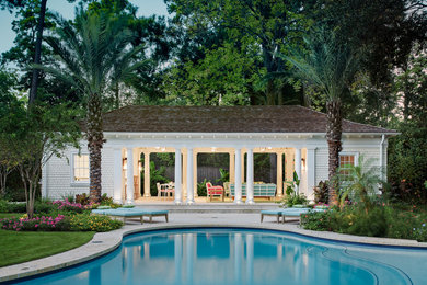 Transitional yellow one-story wood exterior home idea in Houston with a hip roof and a shingle roof