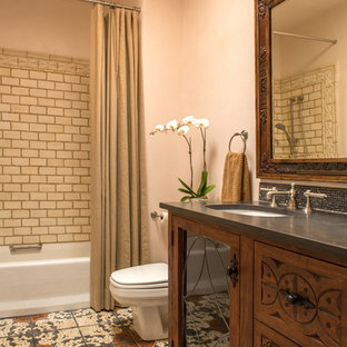 Example of a mid-sized classic master multicolored tile and terra-cotta tile terra-cotta floor bathroom design in Albuquerque with an undermount sink, furniture-like cabinets, medium tone wood cabinets, a one-piece toilet and beige walls