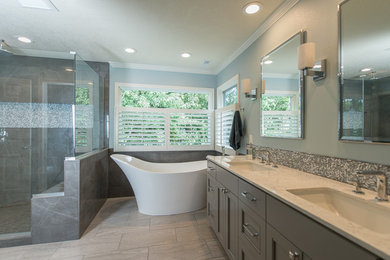 Example of a mid-sized transitional master gray tile and porcelain tile porcelain tile and gray floor bathroom design in Portland with recessed-panel cabinets, gray cabinets, gray walls, an undermount sink, marble countertops, a hinged shower door and white countertops