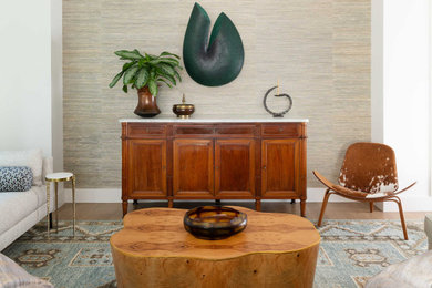 Trendy formal and open concept medium tone wood floor, brown floor and wallpaper living room photo in Dallas with no fireplace and no tv