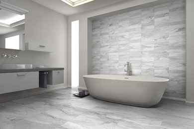 Design ideas for a large modern master bathroom in New York with a freestanding tub, gray tile, porcelain tile, grey walls, porcelain floors, a vessel sink, solid surface benchtops, grey floor, flat-panel cabinets and white cabinets.