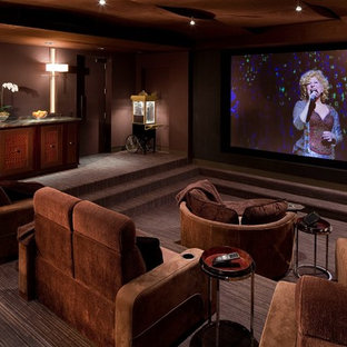 Design ideas for a large contemporary enclosed home cinema in Las Vegas with brown walls, carpet, a projector screen and brown floors.