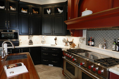Kitchen - large traditional l-shaped limestone floor and beige floor kitchen idea in Miami with a single-bowl sink, raised-panel cabinets, black cabinets, quartzite countertops, white backsplash, stone slab backsplash, stainless steel appliances and two islands