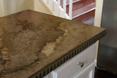 Inspiration for a 1950s dark wood floor eat-in kitchen remodel in Denver with an undermount sink, glass-front cabinets, white cabinets, concrete countertops, brown backsplash, glass tile backsplash and an island
