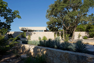 Photo of a large contemporary one-storey white house exterior in Austin with a flat roof.