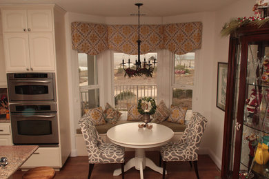 Inspiration for a mid-sized transitional laminate floor and brown floor kitchen/dining room combo remodel in San Francisco with beige walls