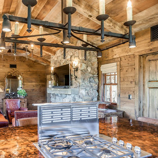 Cette image montre une arrière-cuisine chalet en L de taille moyenne avec un évier 1 bac, un placard à porte plane, des portes de placard beiges, un plan de travail en cuivre, une crédence multicolore, une crédence en carreau de porcelaine, un électroménager en acier inoxydable, un sol en bois brun et un îlot central.