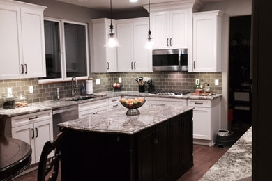 Large transitional medium tone wood floor kitchen photo in Denver with shaker cabinets, granite countertops, stainless steel appliances and an island