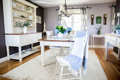 Inspiration for a mid-sized farmhouse medium tone wood floor and brown floor kitchen/dining room combo remodel in Boston with brown walls and no fireplace