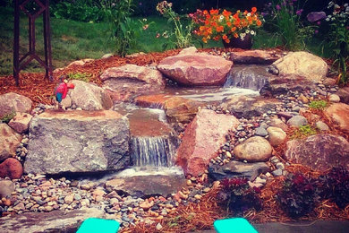 This is an example of a garden in Minneapolis with a waterfall.