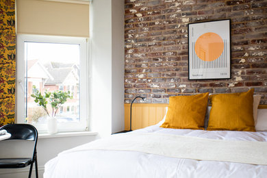This is an example of a medium sized modern guest bedroom in London.