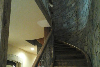 Inspiration for a mid-sized craftsman wooden curved mixed material railing staircase remodel in Other with wooden risers