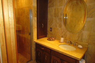 Elegant yellow tile and stone slab alcove shower photo in Seattle with an undermount sink, beaded inset cabinets, dark wood cabinets, marble countertops and a one-piece toilet
