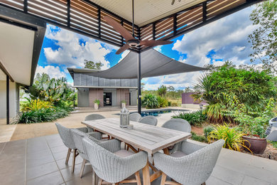 Inspiration for an expansive contemporary backyard patio in Darwin with concrete slab and a roof extension.