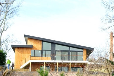 Contemporary Bi level home with wood and stone veneer siding on the South River