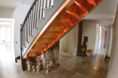 Design ideas for a medium sized country wood straight staircase with metal risers.