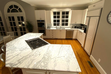 Example of a large eat-in kitchen design in Charlotte with marble countertops, gray backsplash, marble backsplash, an island and gray countertops